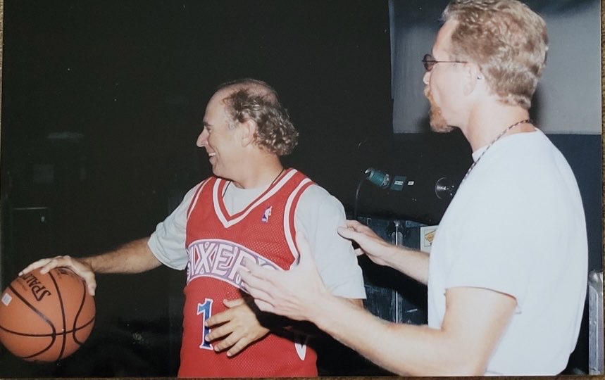 Musician jimmy buffett wearing a red sixers jersey with pat croce